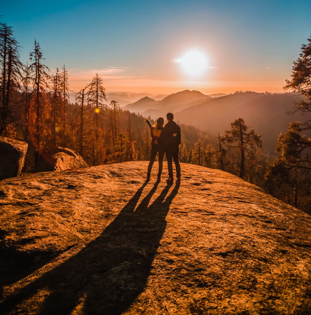 A couple watching the sunset over the mountains